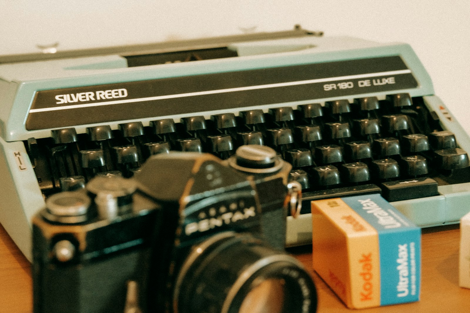 a camera and a typewriter sitting on a table